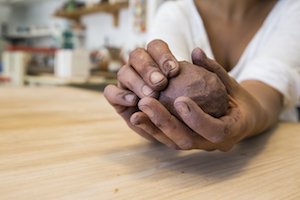 woman playing with clay