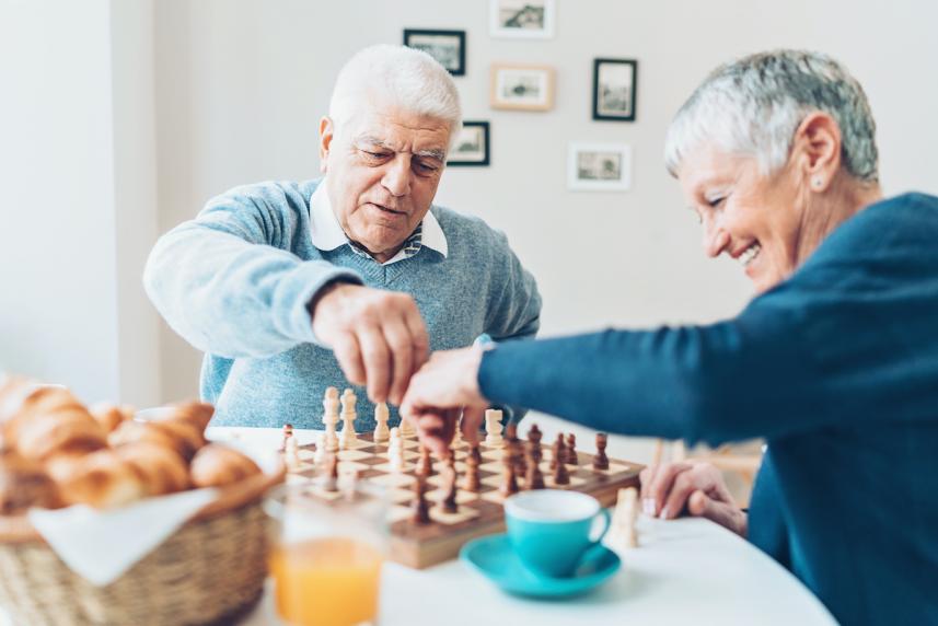 older couple playing a board game