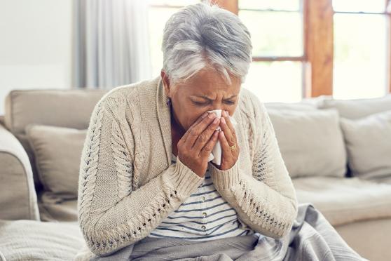 Women blowing her nose into a tissue