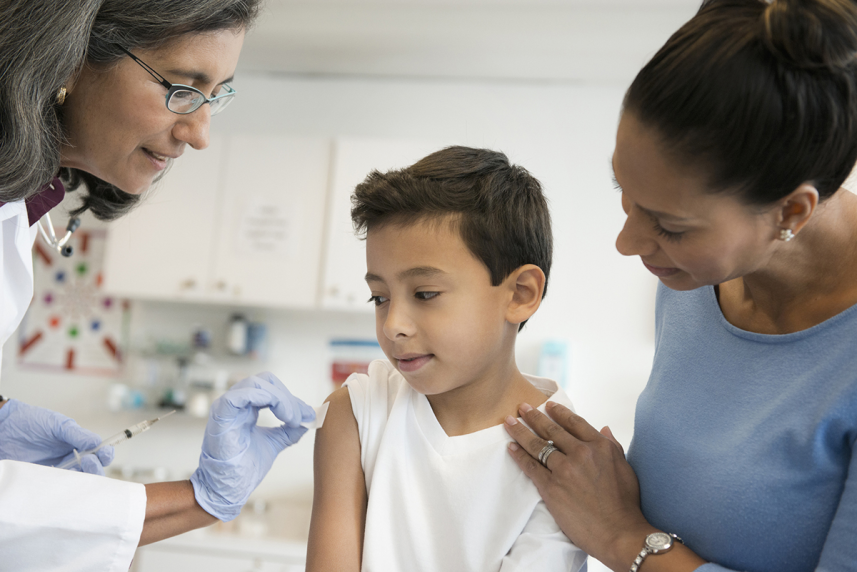 Mother with young son at doctor getting vaccine