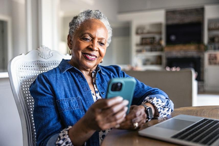 Woman smiling looking at her phone.