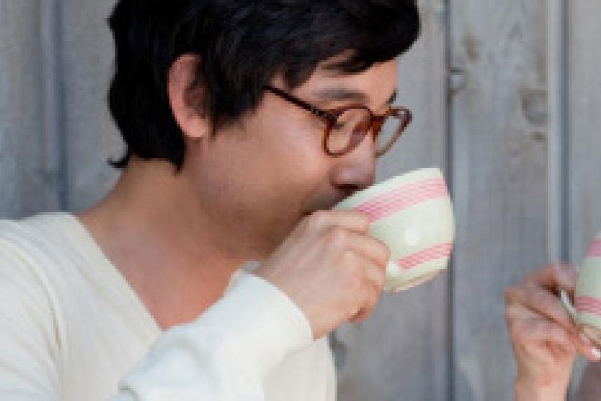 Photo: Young man and woman drinking cups of coffee