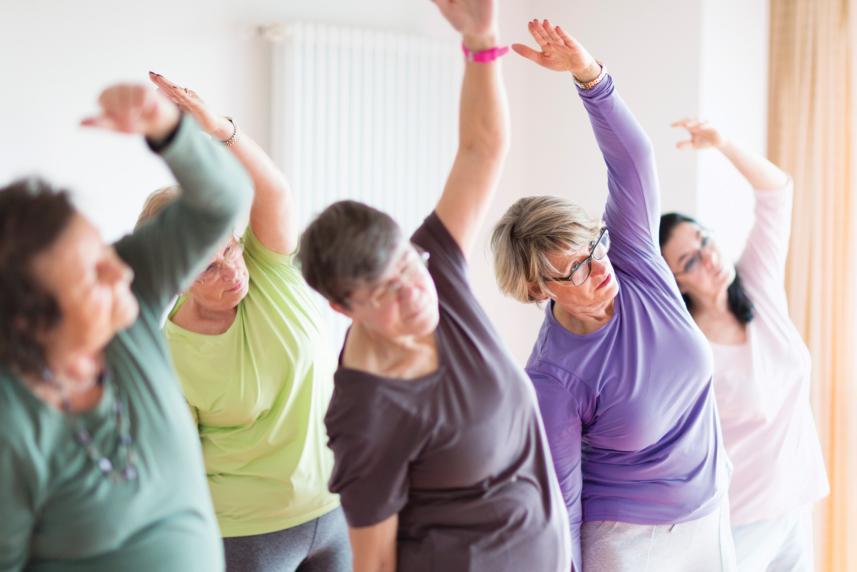 Photo: Women stretching in fitness class.