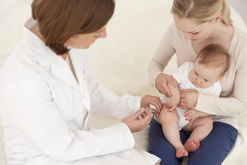 Doctor administering vaccine to a baby