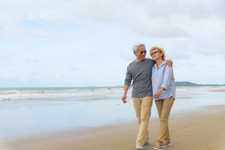 Older couple taking a walk on the beach