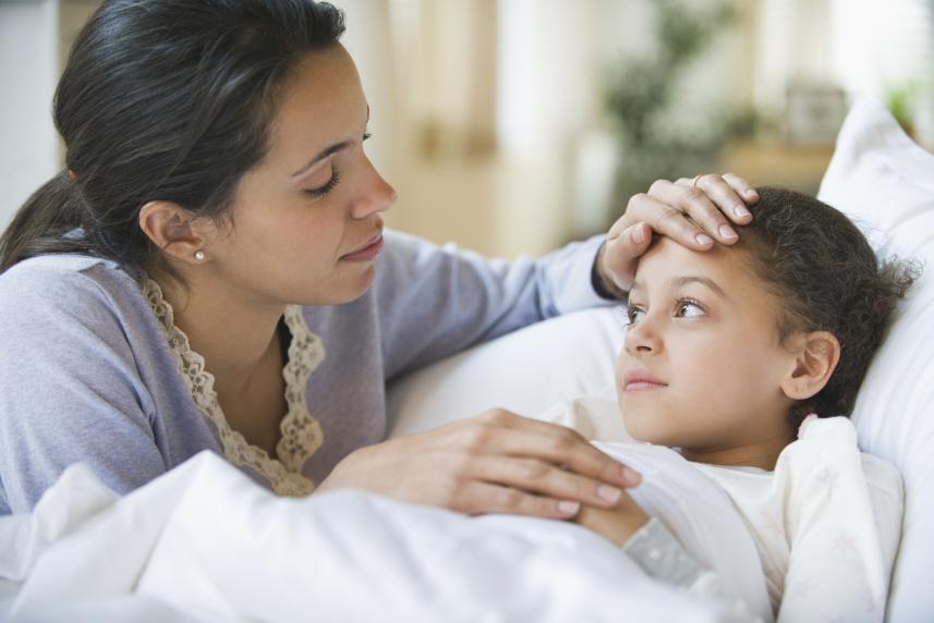 woman checking temperature of child