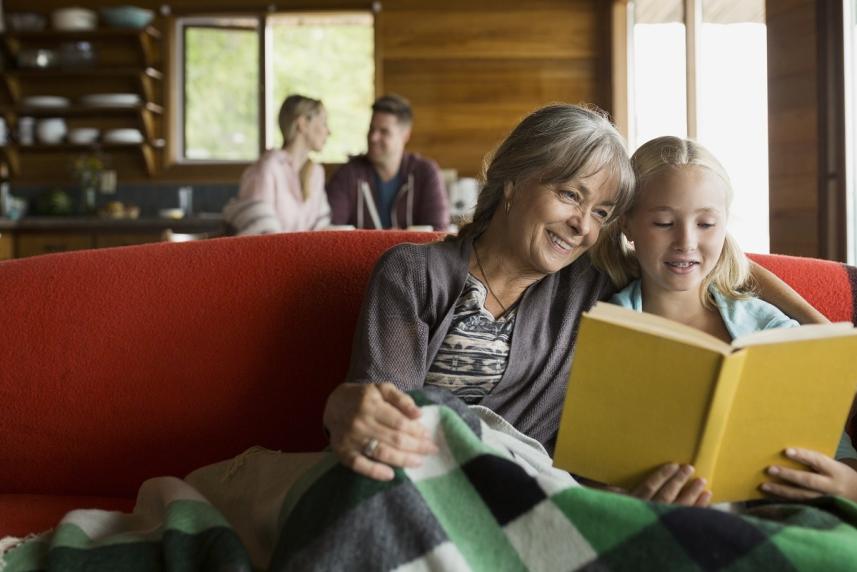 Grandmother and granddaughter reading a book together