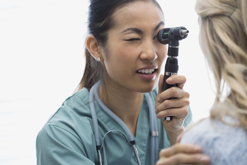 Nurse checking patient's eyes