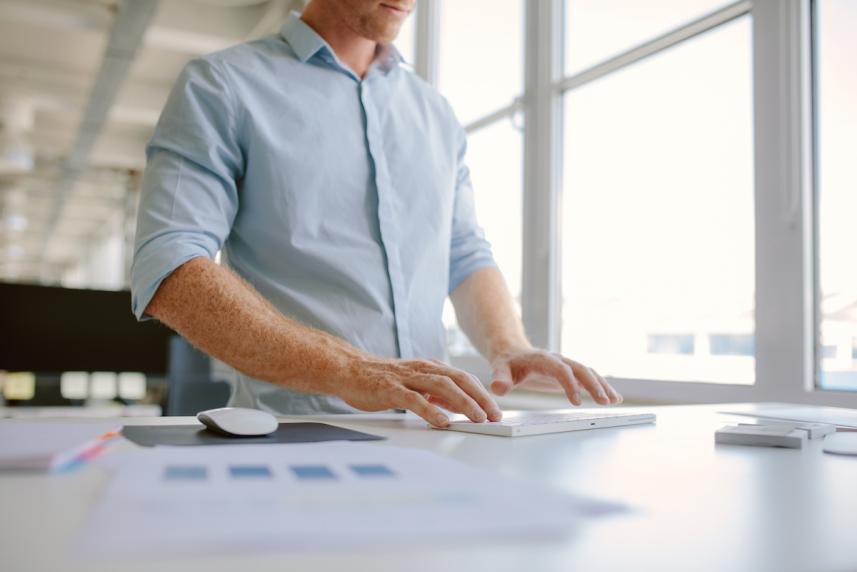 man standing up at desk