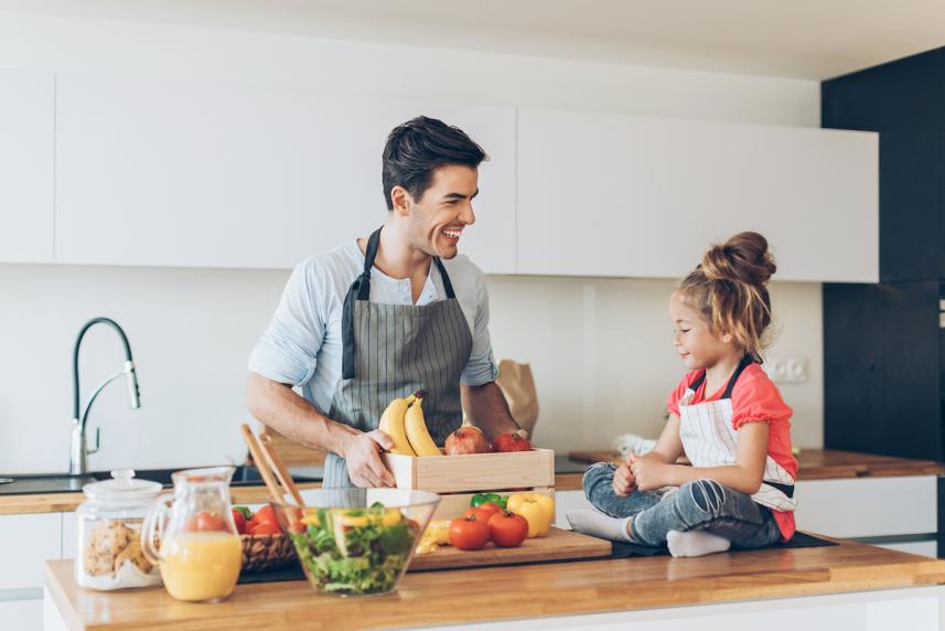 Dad and young daughter cooking together