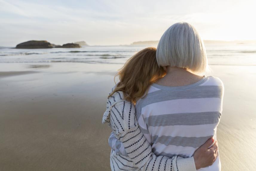 younger woman hugging older woman