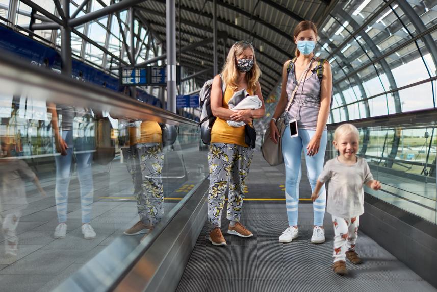 People in an airport wearing masks