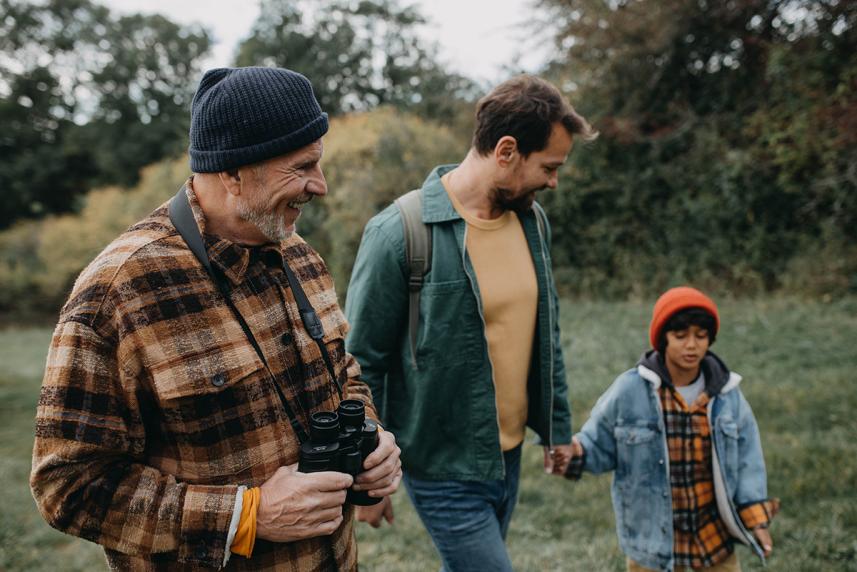 Senior, adult, and child walking