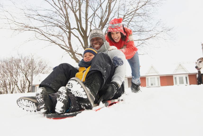 Photo: Happy family playing in the snow in winter