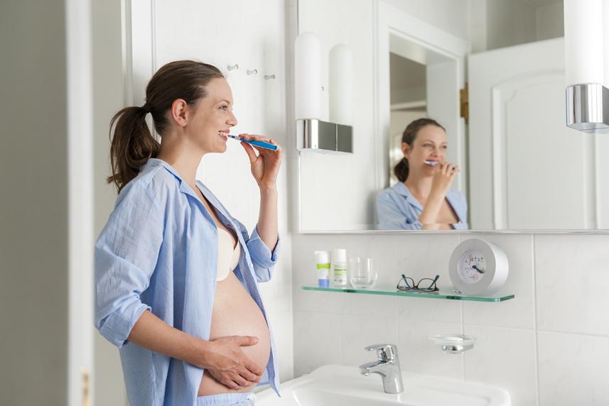 Pregnant woman brushing teeth