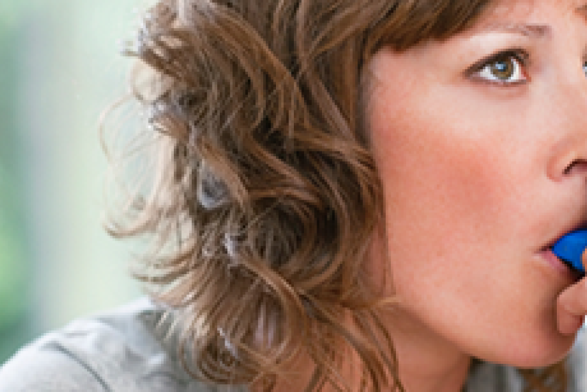 Woman using inhaler