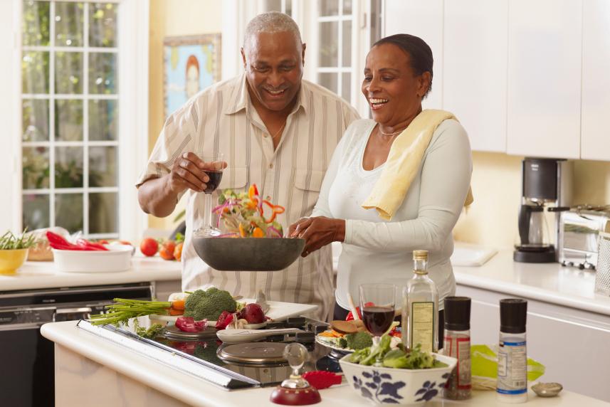 Photo: Man and woman cooking a healthy meal together.