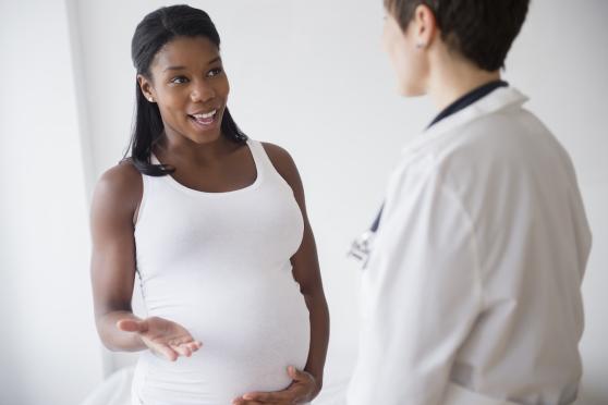 Pregnant woman talking with her doctor