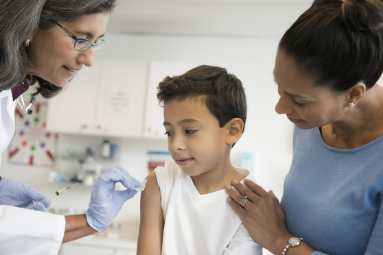 Mother with young son at doctor getting vaccine