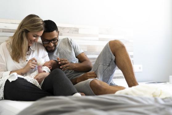 New parents feeding infant