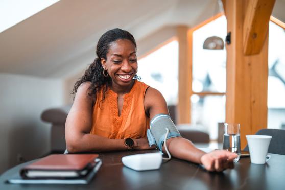 Woman taking blood pressure at home