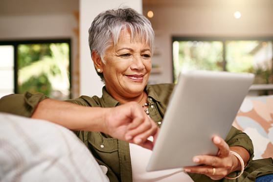 Photo: Mature woman browsing on her tablet