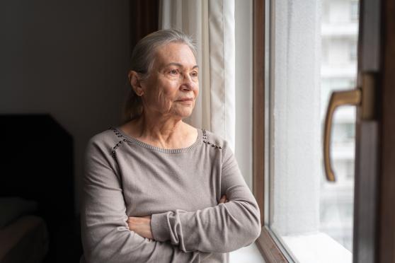 Person with depression looking out the window