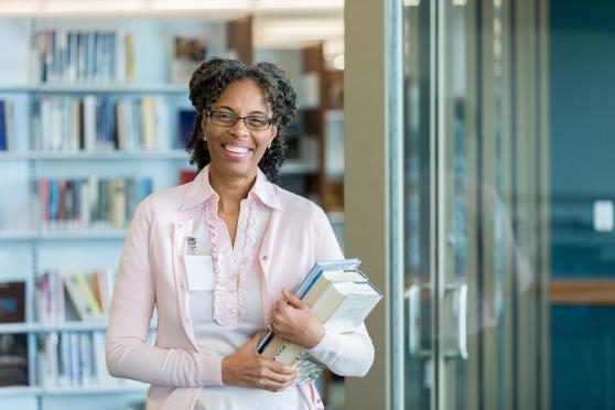 Liberian holding books and smiling