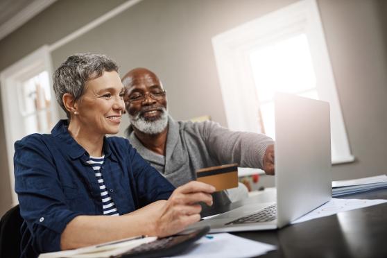 Senior couple looking at laptop