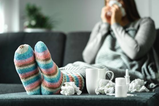 woman coughing on the couch