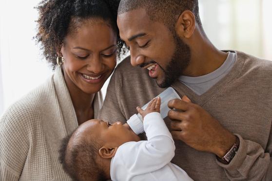 Smiling parent with newborn