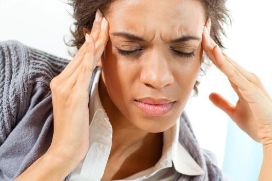 Photo: woman rubbing temples/forehead