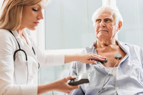 doctor checking patient's heart