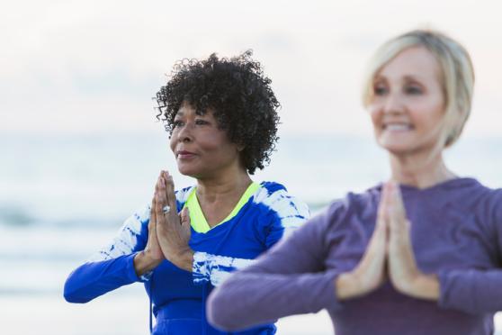 older women doing yoga