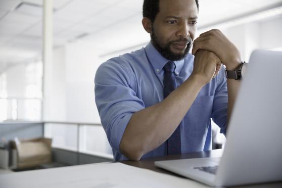 man sitting at desk, stressed