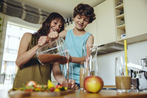 mom and child making smoothie