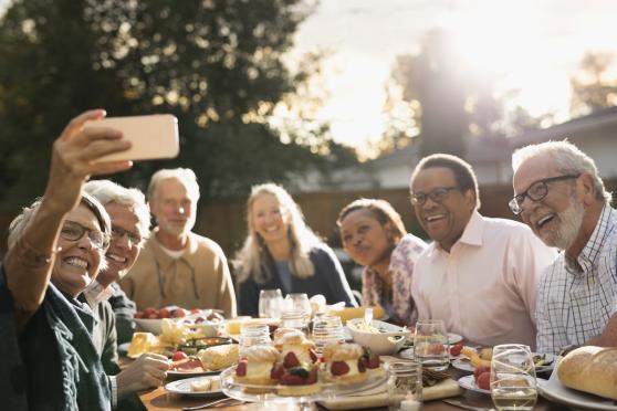  Group of men and women talking at an outdoor party