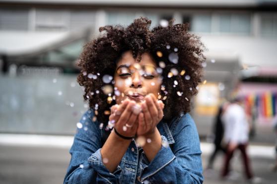 woman blowing on flowers