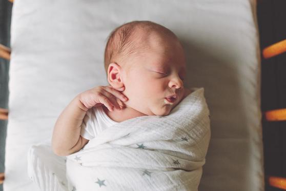 Swaddled Baby Sleeping in crib