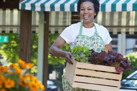 Lady with fresh produce at a local farmers market