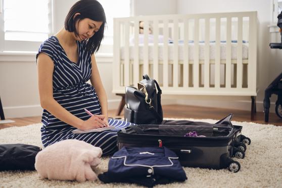 Pregnant woman packing bag