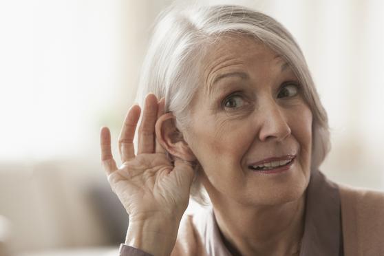 A woman struggles to hear.