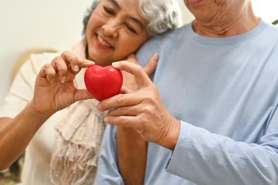 Man and woman holding a heart.