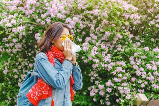 woman sneezing in tissue