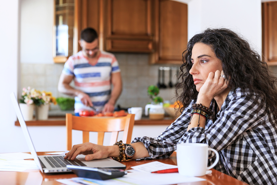 Woman looking at her laptop computer, concerned