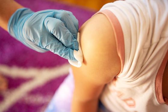 Child receiving a vaccine.